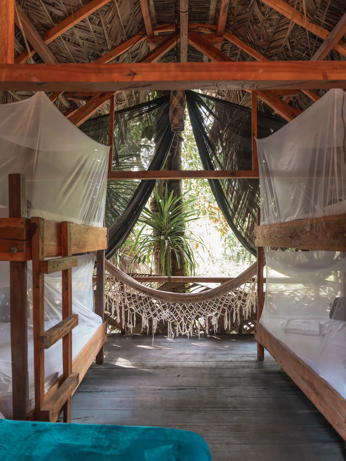 Literas enfrentadas y hamaca al fondo del Glamping Clan y Manada
